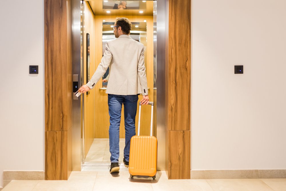 man entering a hotel lift